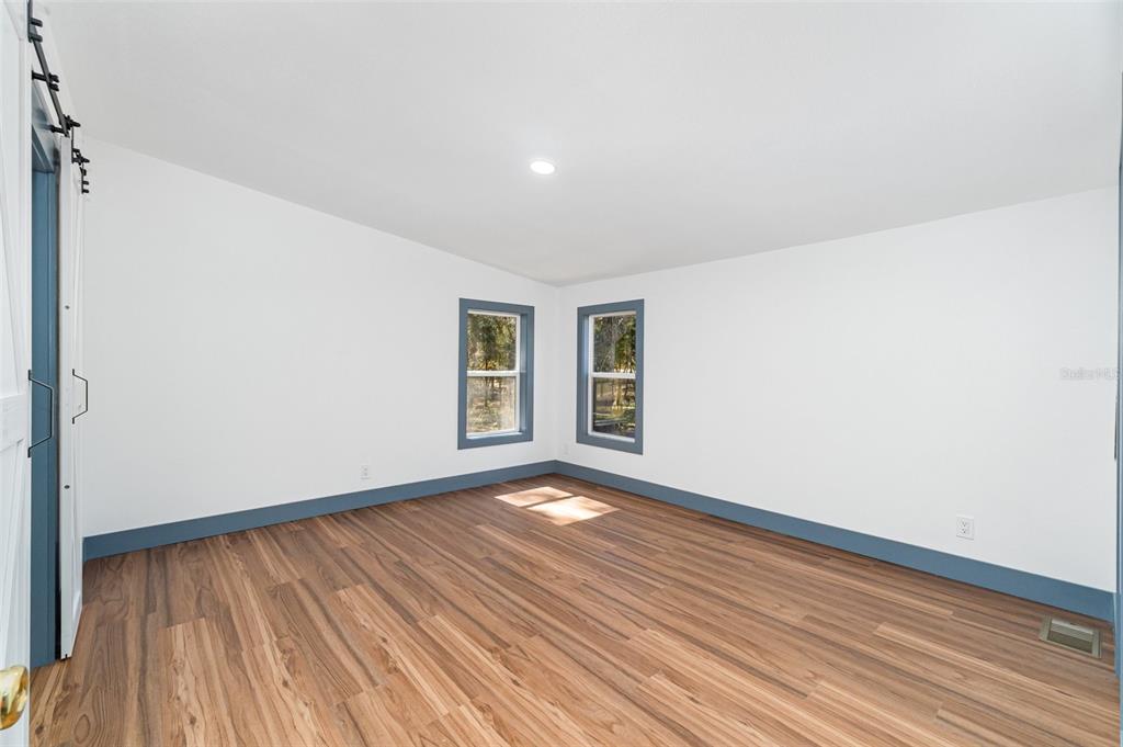 4664 Southwest 181st Court Dunnellon, FL 34432 - Photo 8 of 46 a view of an empty room with wooden floor and a window