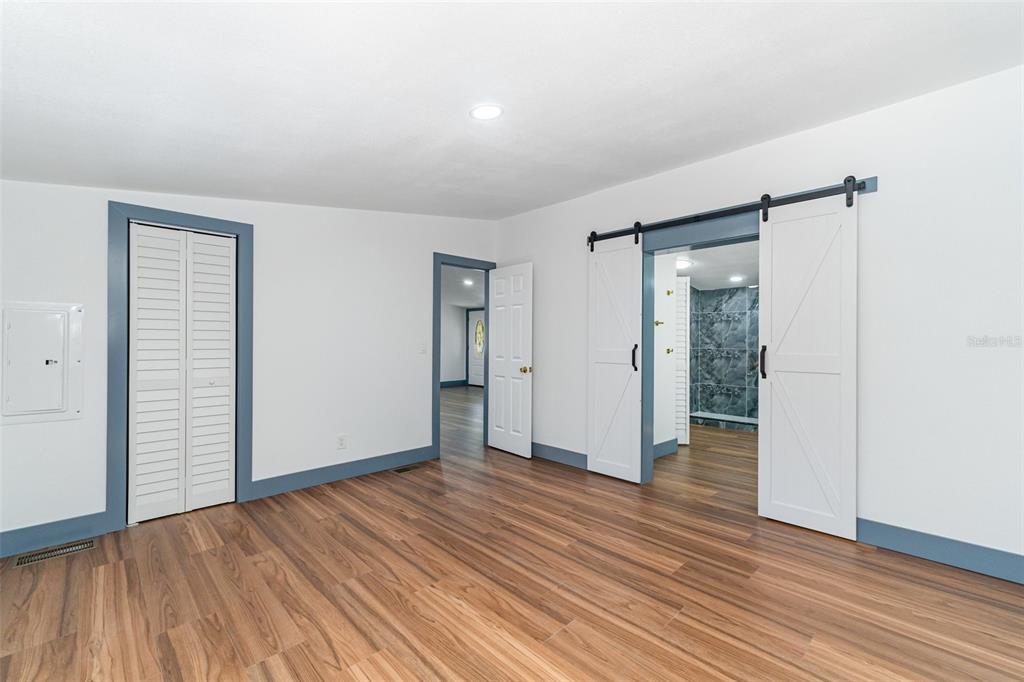 4664 Southwest 181st Court Dunnellon, FL 34432 - Photo 9 of 46 an empty room with wooden floor and entrance