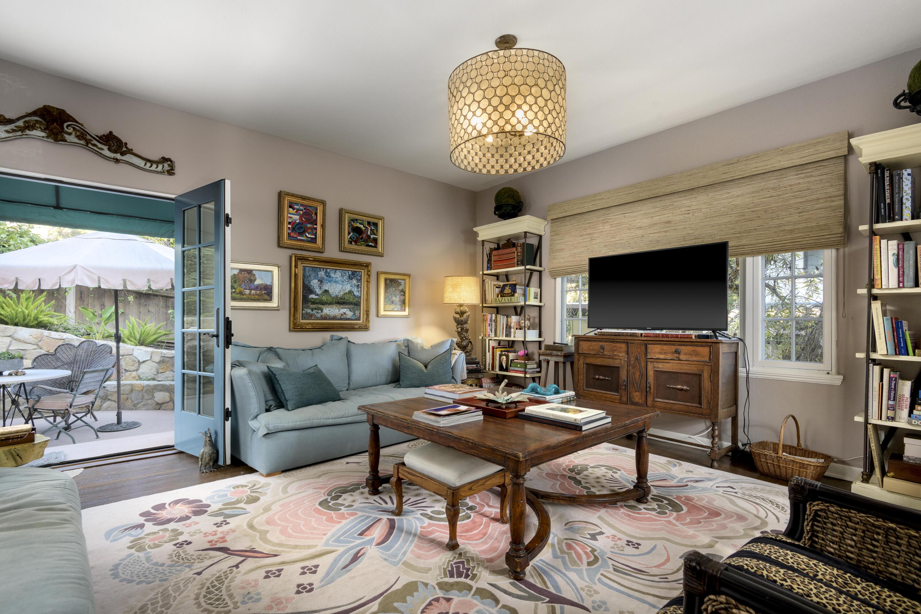 1318 Alta Vista Road Santa Barbara, CA 93103 - Photo 11 of 44 a living room with furniture a chandelier and a flat screen tv