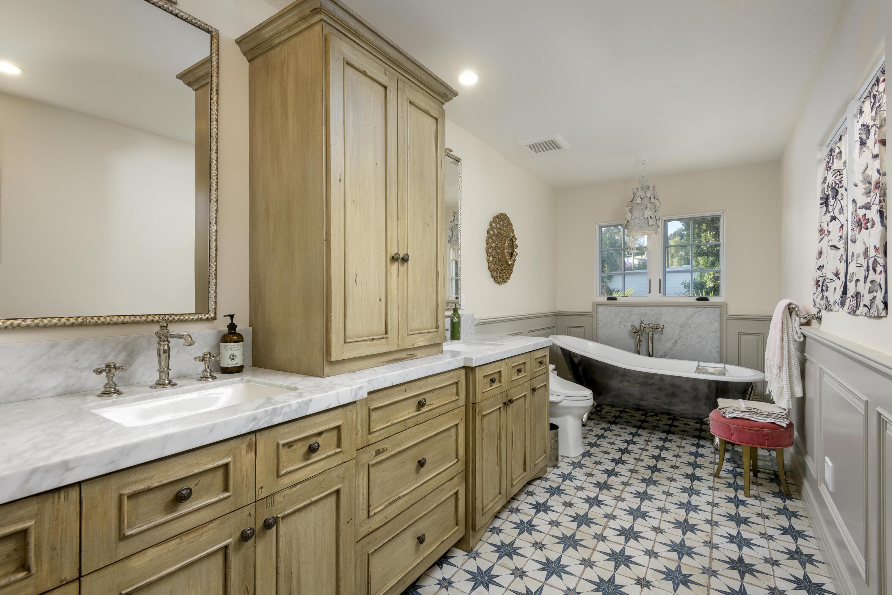 1318 Alta Vista Road Santa Barbara, CA 93103 - Photo 22 of 44 a spacious bathroom with a granite countertop sink mirror and a bathtub