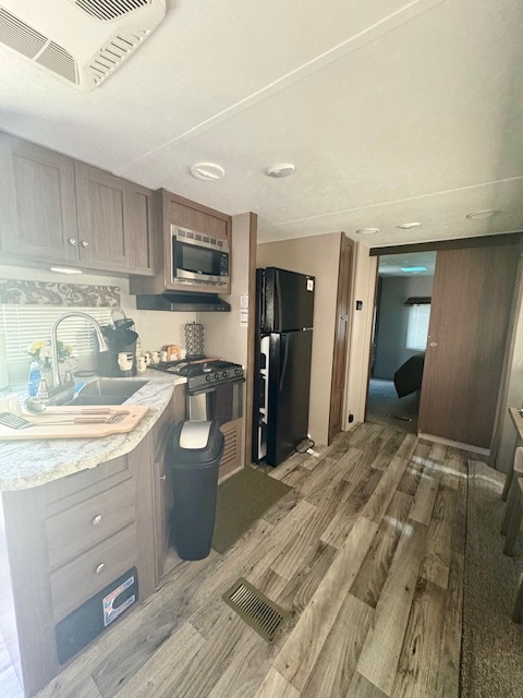 24-22 Woodhaven Sublette, IL 61367 - Photo 13 of 24 a kitchen with stainless steel appliances granite countertop a refrigerator and a sink