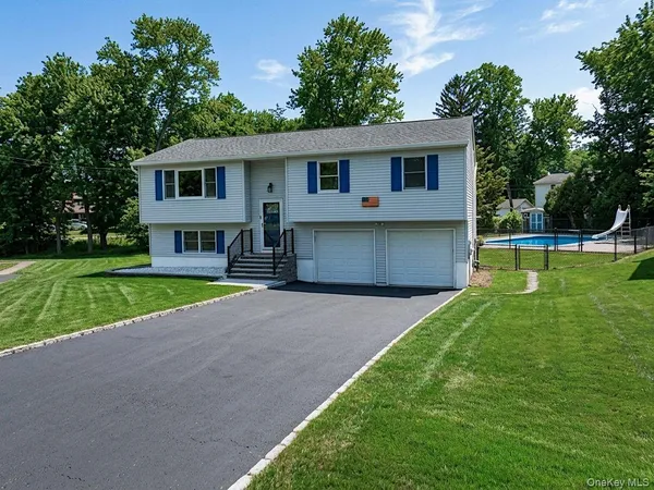 a front view of house with yard and green space