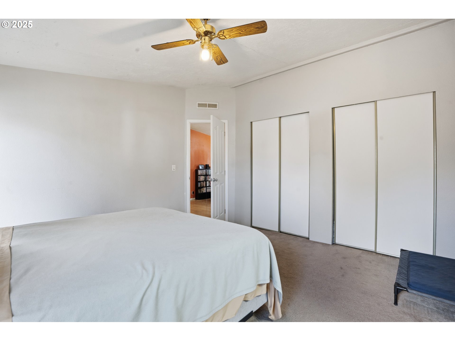 1949 Southeast Palmquist Road, Unit 32 Gresham, OR 97080 - Photo 12 of 31 a bedroom with a bed and a chandelier