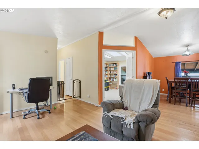 a living room with furniture and a book shelf