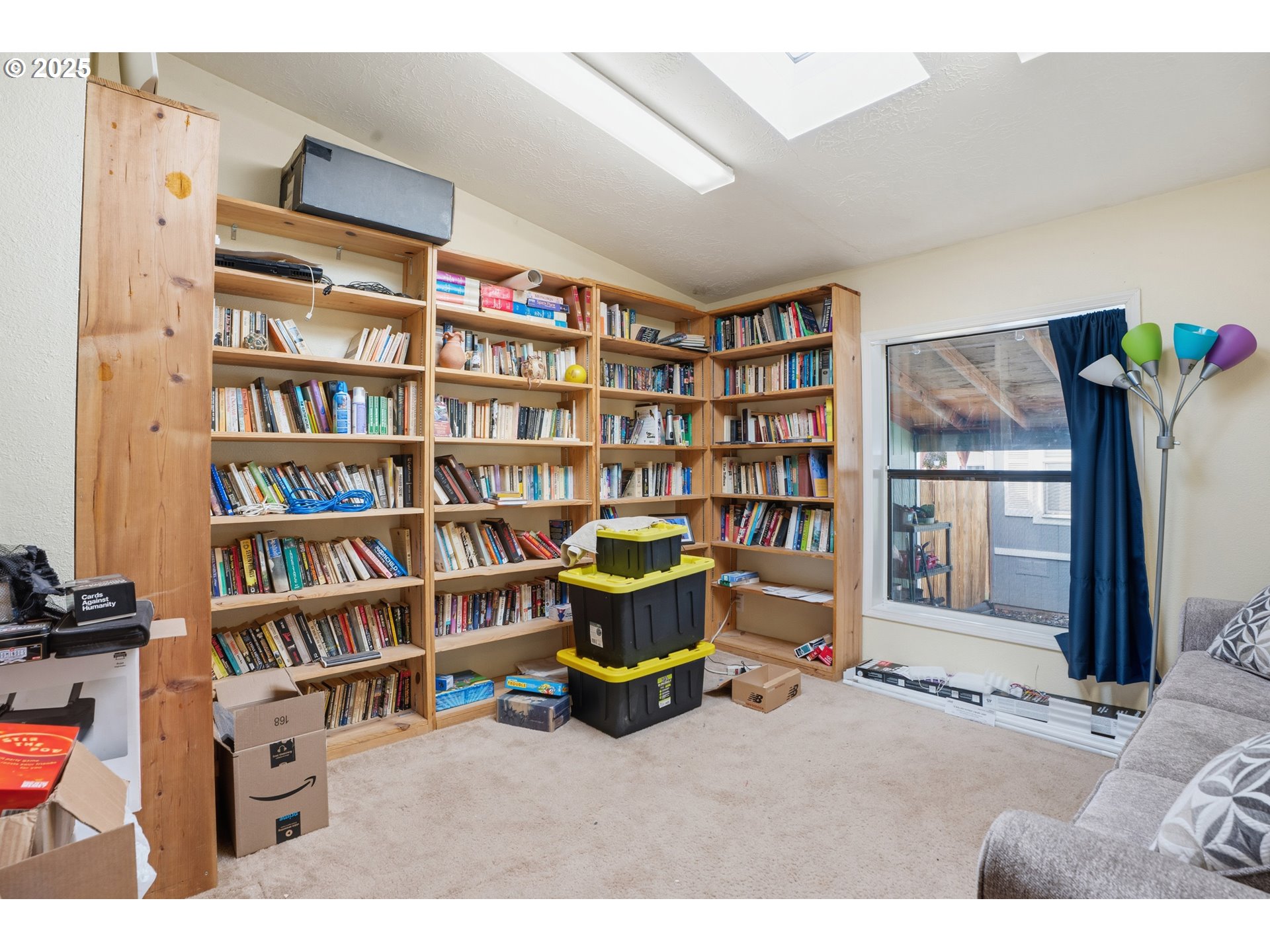 1949 Southeast Palmquist Road, Unit 32 Gresham, OR 97080 - Photo 15 of 31 a living room with furniture and a book shelf