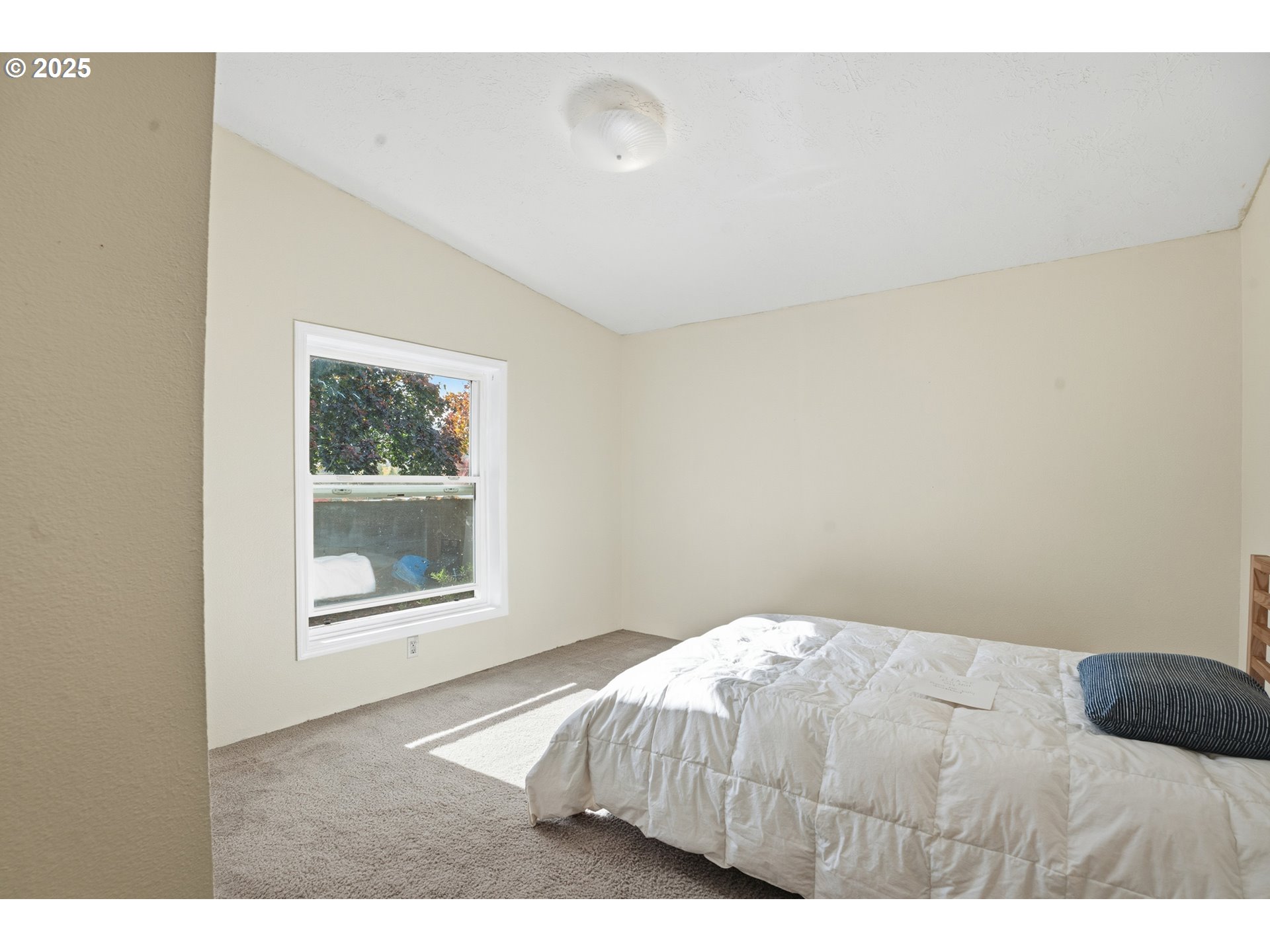 1949 Southeast Palmquist Road, Unit 32 Gresham, OR 97080 - Photo 18 of 31 a bedroom with a bed and a window