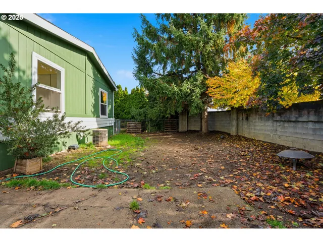 a aerial view of a house with a yard and a large tree