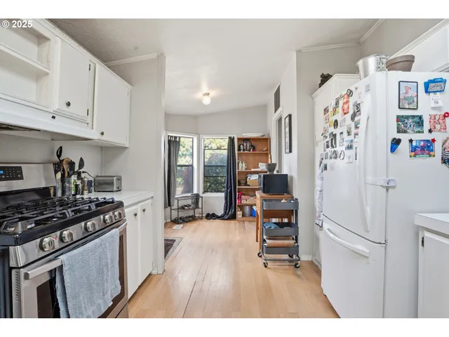 a kitchen with stainless steel appliances a refrigerator a stove a sink and a cabinets