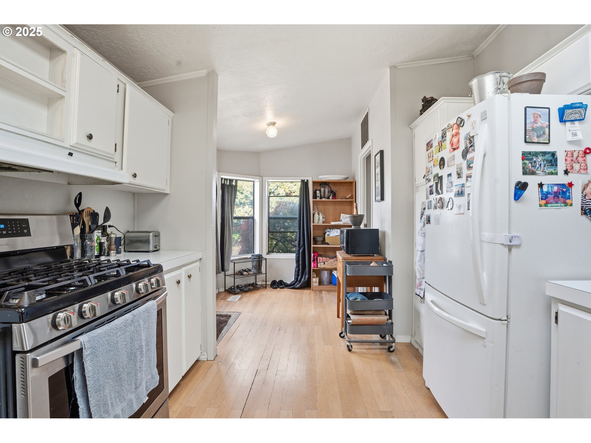 1949 Southeast Palmquist Road, Unit 32 Gresham, OR 97080 - Photo 9 of 31 a kitchen with stainless steel appliances a refrigerator a stove a sink and a cabinets