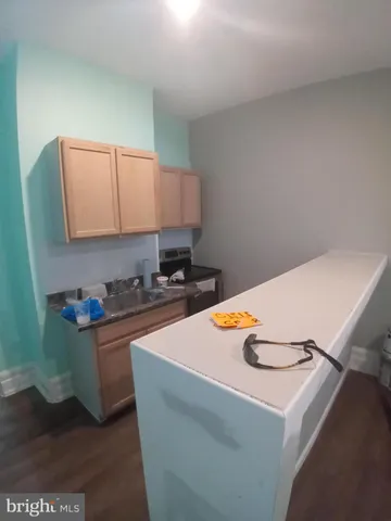 a kitchen with stainless steel appliances a stove a sink and a refrigerator