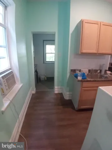 a room with wooden floor and window