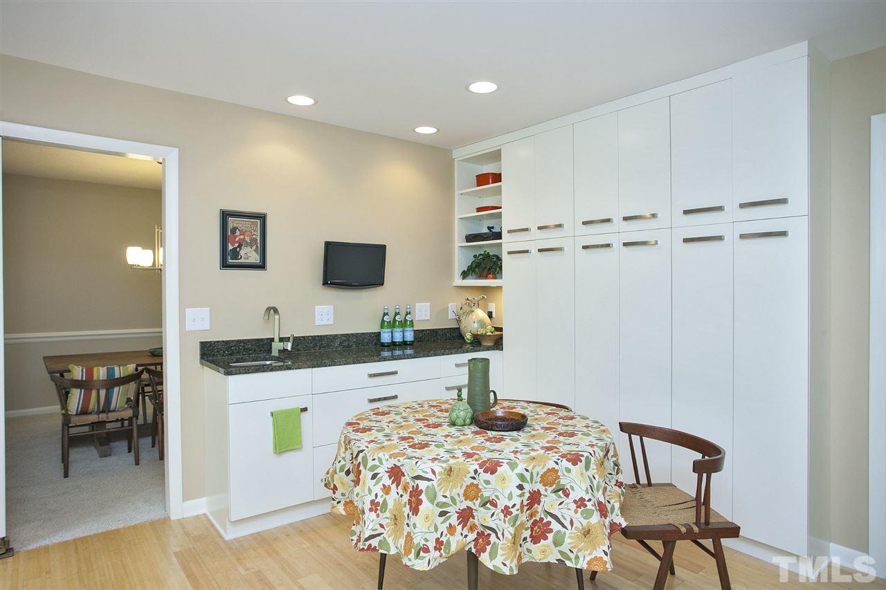9605 Rock Creek Road Raleigh, NC 27613 - Photo 11 of 25 a kitchen with granite countertop a white cabinets and chairs