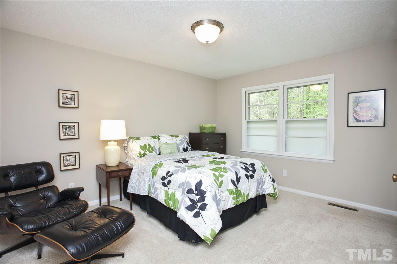 9605 Rock Creek Road Raleigh, NC 27613 - Photo 16 of 25 a bedroom with a bed window and couch