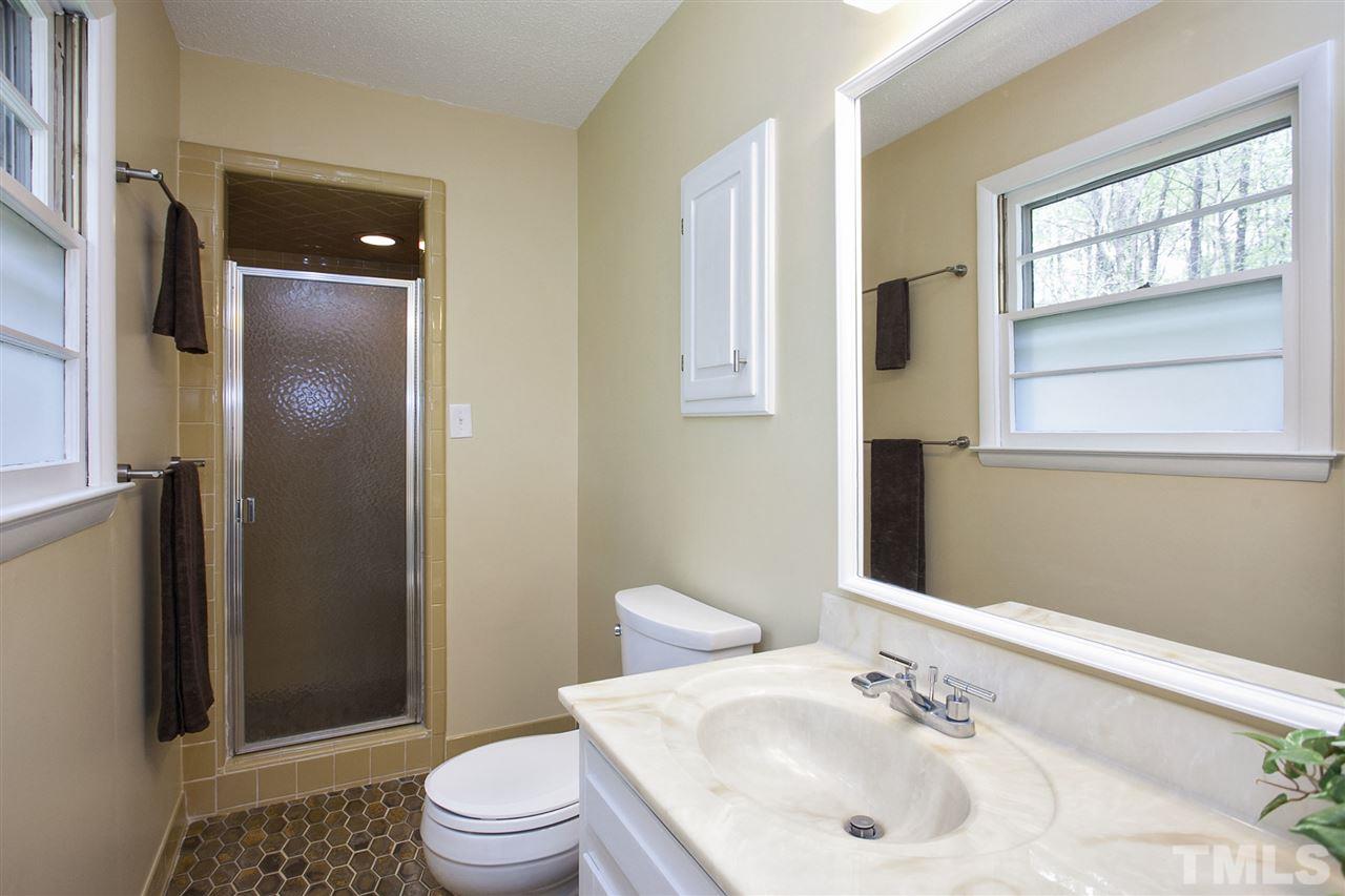 9605 Rock Creek Road Raleigh, NC 27613 - Photo 17 of 25 a bathroom with a sink toilet and shower