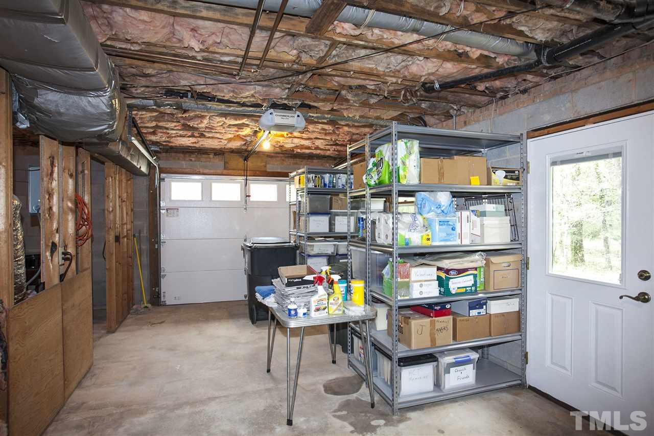 9605 Rock Creek Road Raleigh, NC 27613 - Photo 20 of 25 a room with storage and a furniture