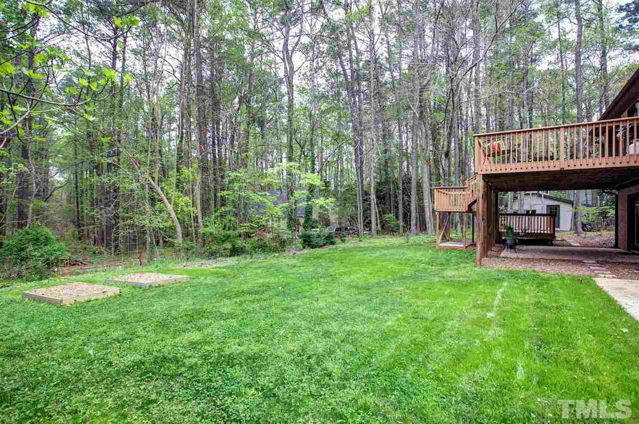 9605 Rock Creek Road Raleigh, NC 27613 - Photo 24 of 25 a view of backyard of house with green space and balcony
