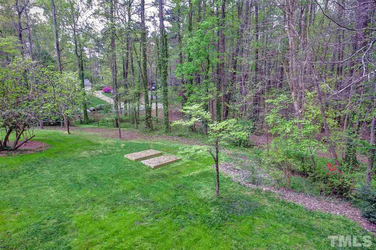 9605 Rock Creek Road Raleigh, NC 27613 - Photo 25 of 25 a view of a backyard with a garden