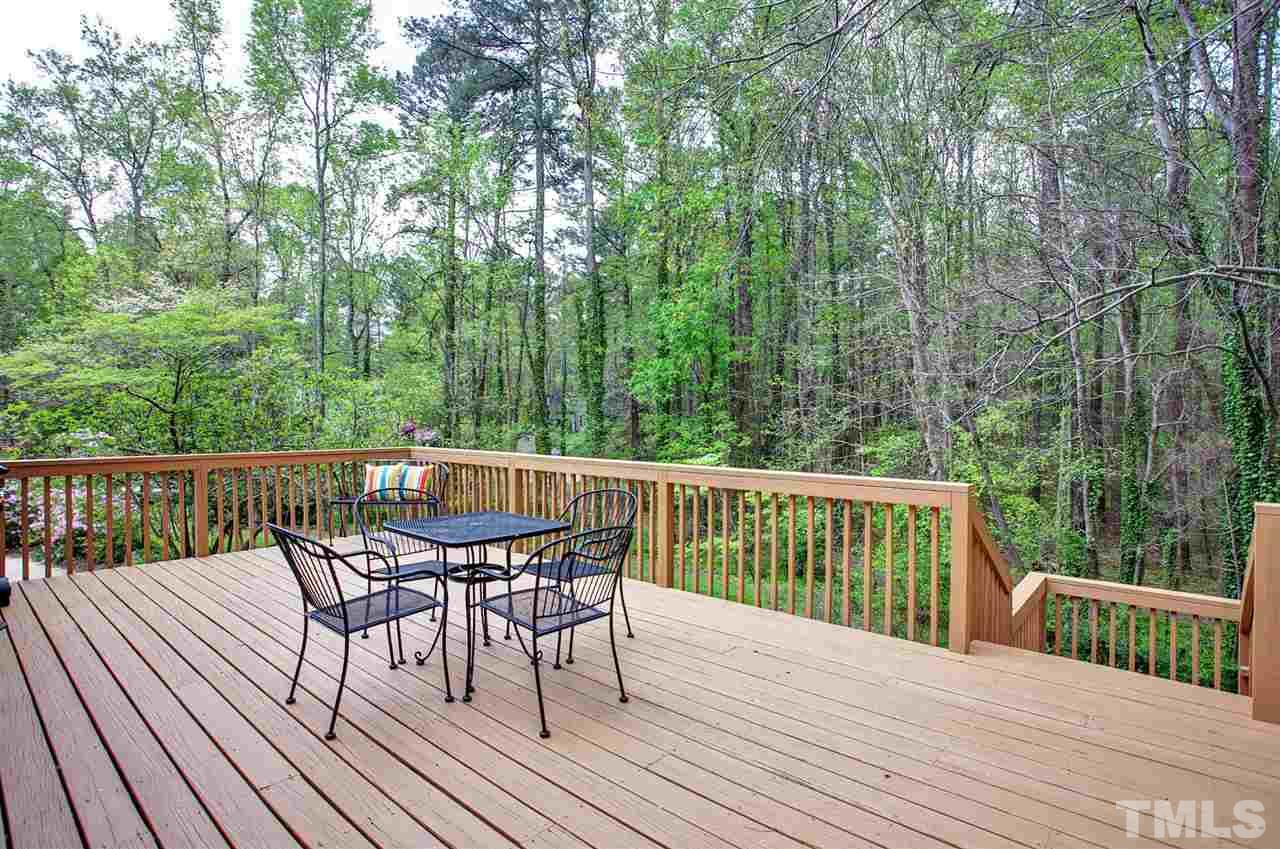 9605 Rock Creek Road Raleigh, NC 27613 - Photo 4 of 25 a view of balcony with furniture and trees around