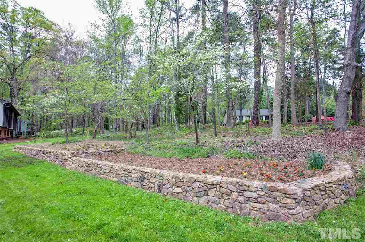 9605 Rock Creek Road Raleigh, NC 27613 - Photo 5 of 25 a view of a backyard with trees