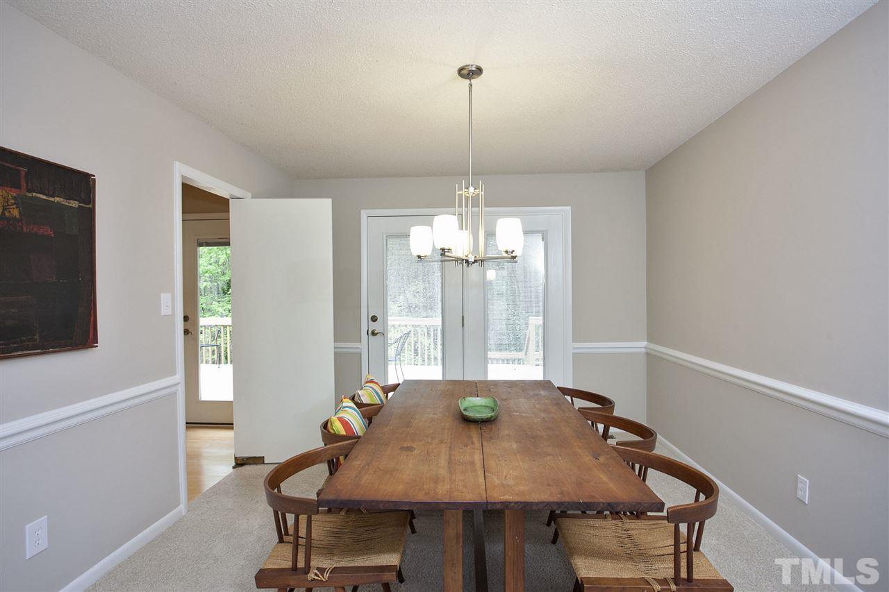9605 Rock Creek Road Raleigh, NC 27613 - Photo 9 of 25 a view of a dining room with furniture window and wooden floor