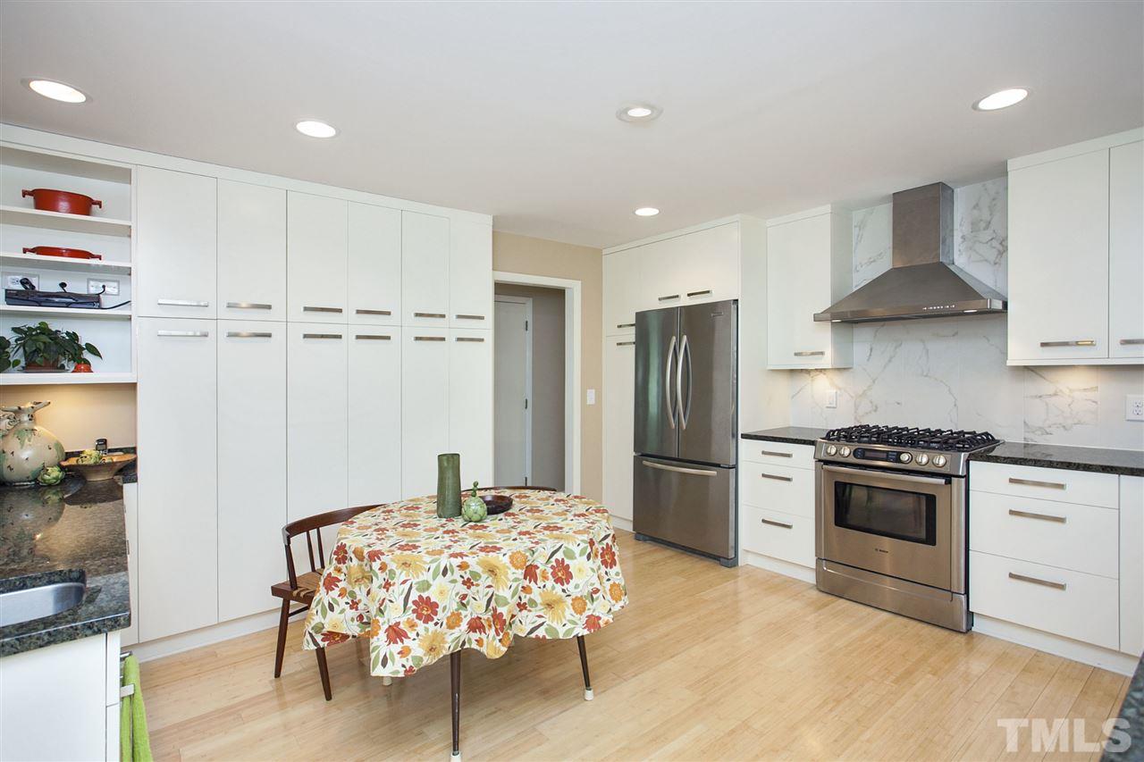 9605 Rock Creek Road Raleigh, NC 27613 - Photo 10 of 25 a kitchen with stainless steel appliances granite countertop a stove and a refrigerator