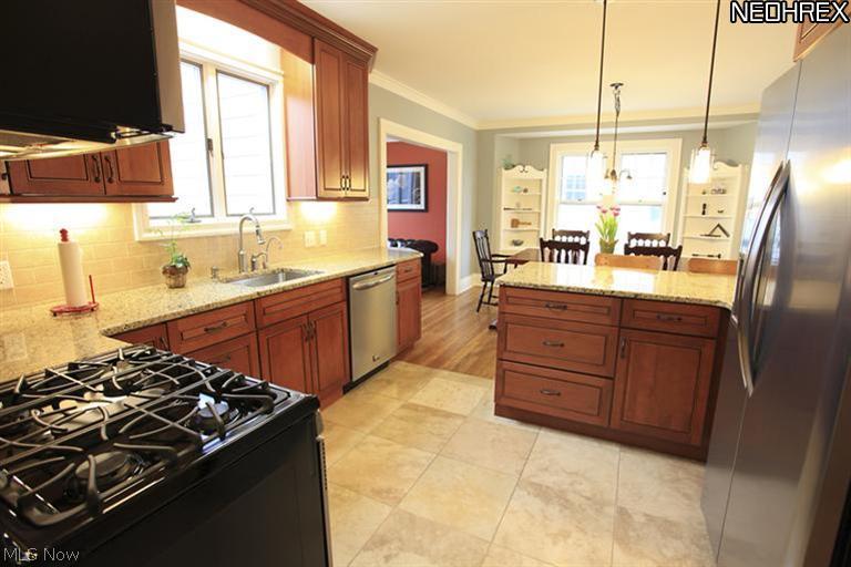 15803 Fernway Road Cleveland, OH 44120 - Photo 8 of 25 This reverse perspective shot of the Updated Kitchen shows off the tile floors and convenient layout making for a great workspace!