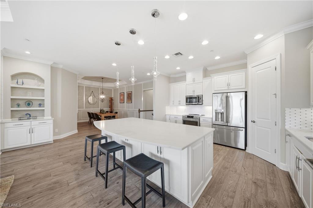 9658 Montelanico Loop, Unit 201 Naples, FL 34119 - Photo 4 of 46 a large kitchen with a table and chairs