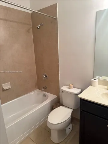 a white toilet sitting next to a bath tub