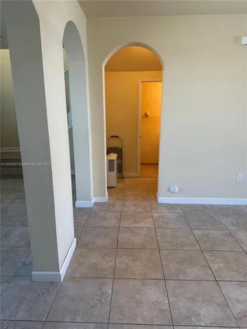 a view of a hallway with a door