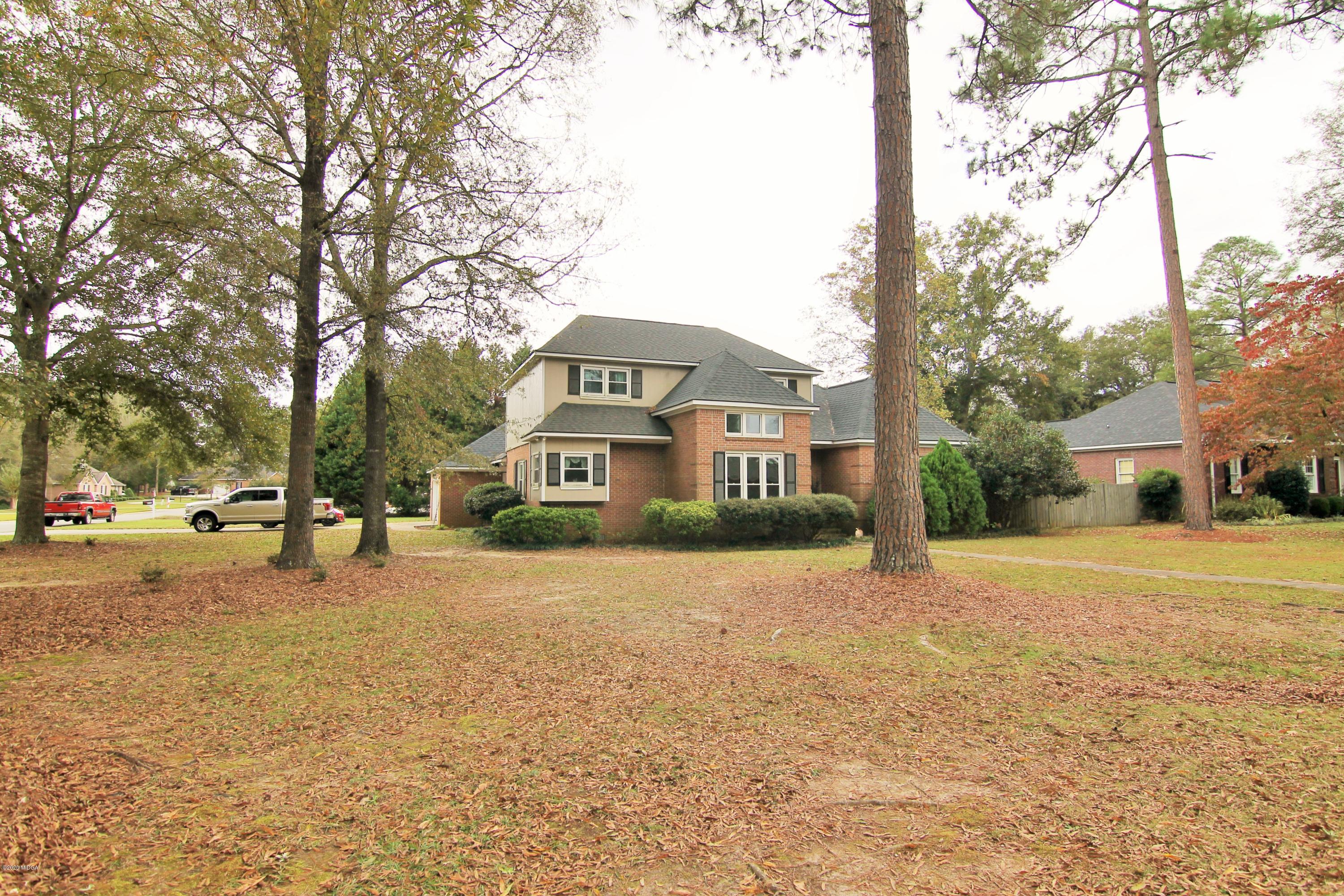 205 Cedar Ridge Drive Perry, GA 31069 - Photo 2 of 39 a front view of a house with a yard and garage