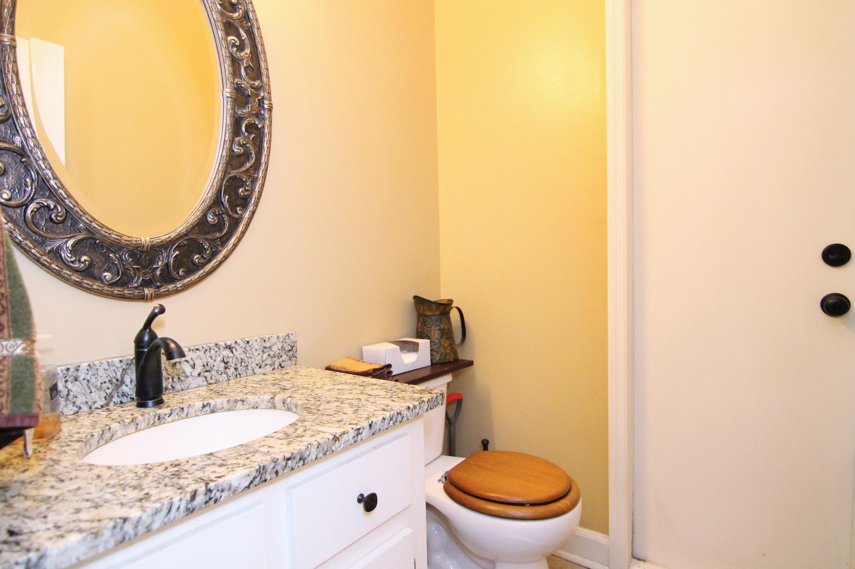 205 Cedar Ridge Drive Perry, GA 31069 - Photo 12 of 39 a bathroom with a granite countertop sink and a mirror
