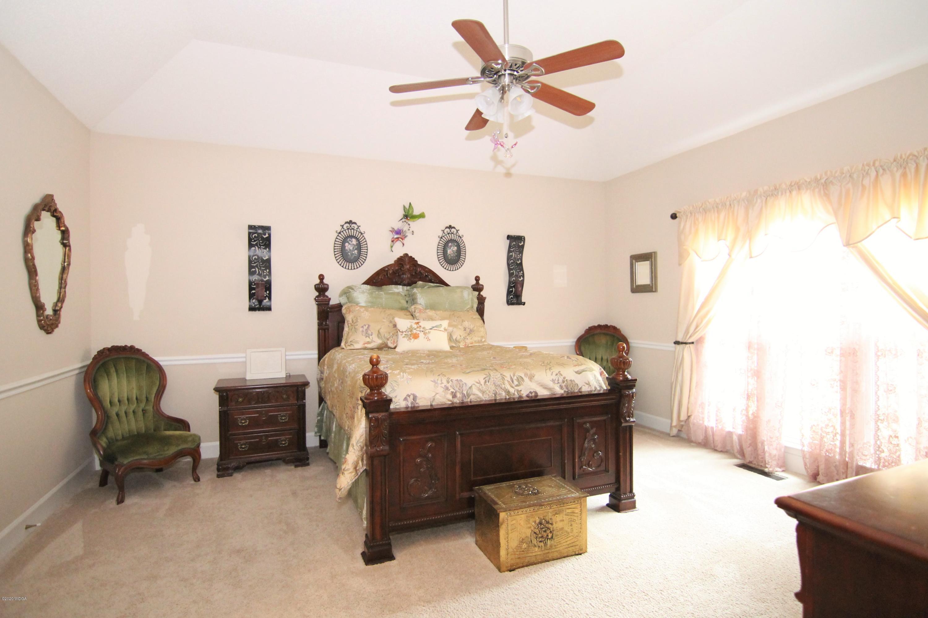 205 Cedar Ridge Drive Perry, GA 31069 - Photo 13 of 39 a bed sitting in a room next to a window