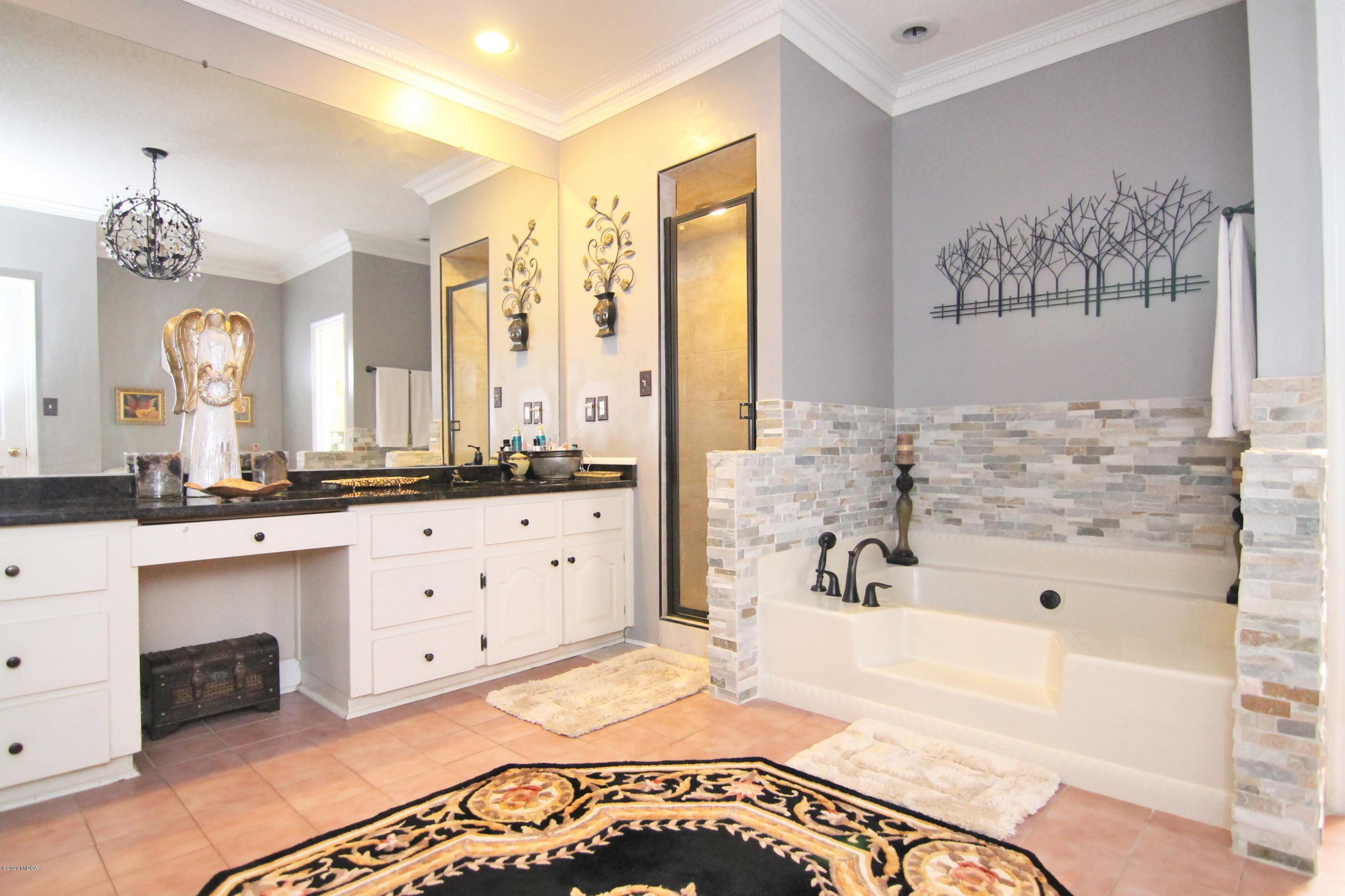 205 Cedar Ridge Drive Perry, GA 31069 - Photo 17 of 39 a spacious bathroom with a tub sink and mirror