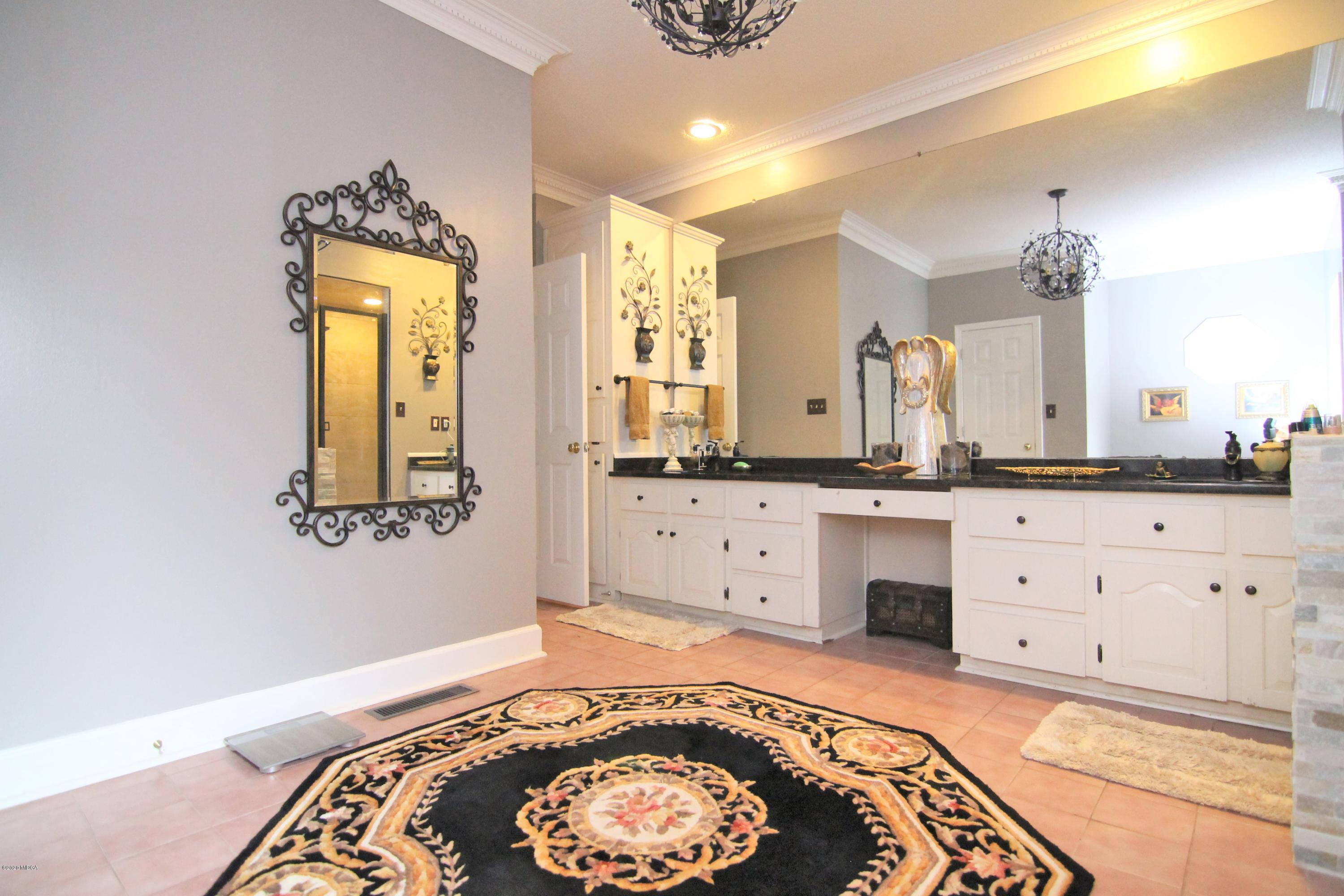 205 Cedar Ridge Drive Perry, GA 31069 - Photo 18 of 39 a spacious bathroom with a double vanity sink and a mirror