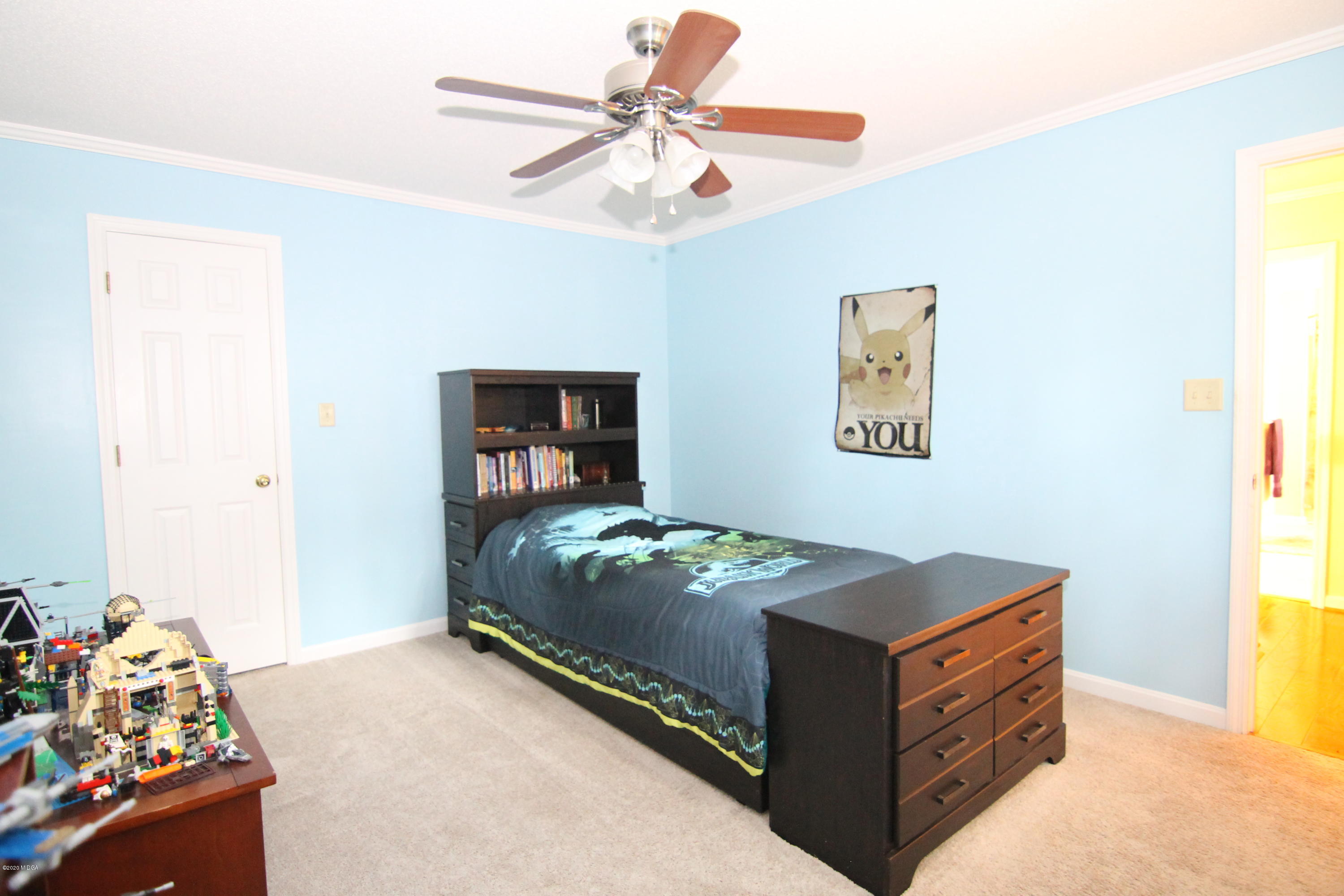 205 Cedar Ridge Drive Perry, GA 31069 - Photo 20 of 39 a bedroom with a bed and a chandelier