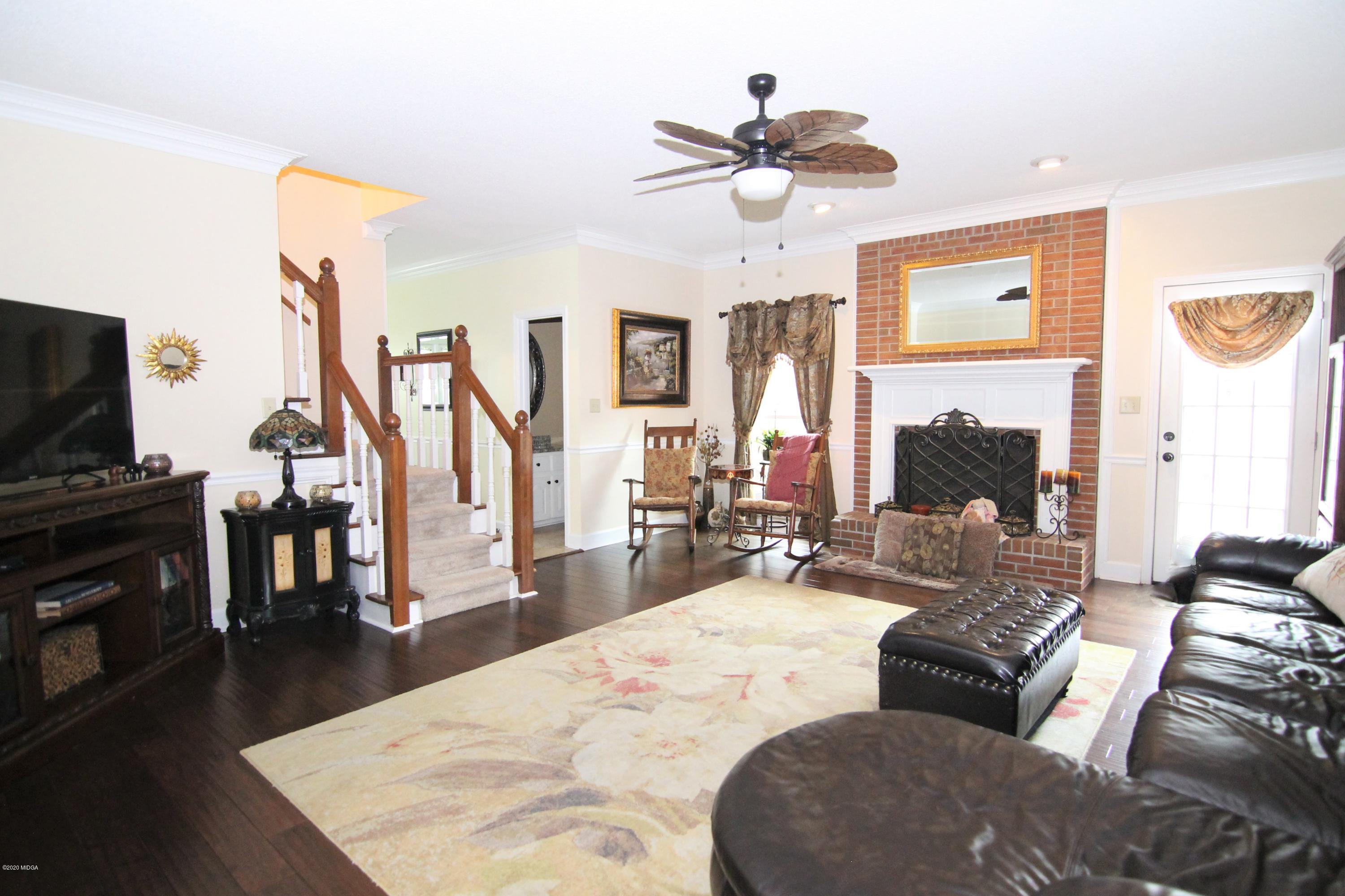 205 Cedar Ridge Drive Perry, GA 31069 - Photo 3 of 39 a living room with furniture and a flat screen tv