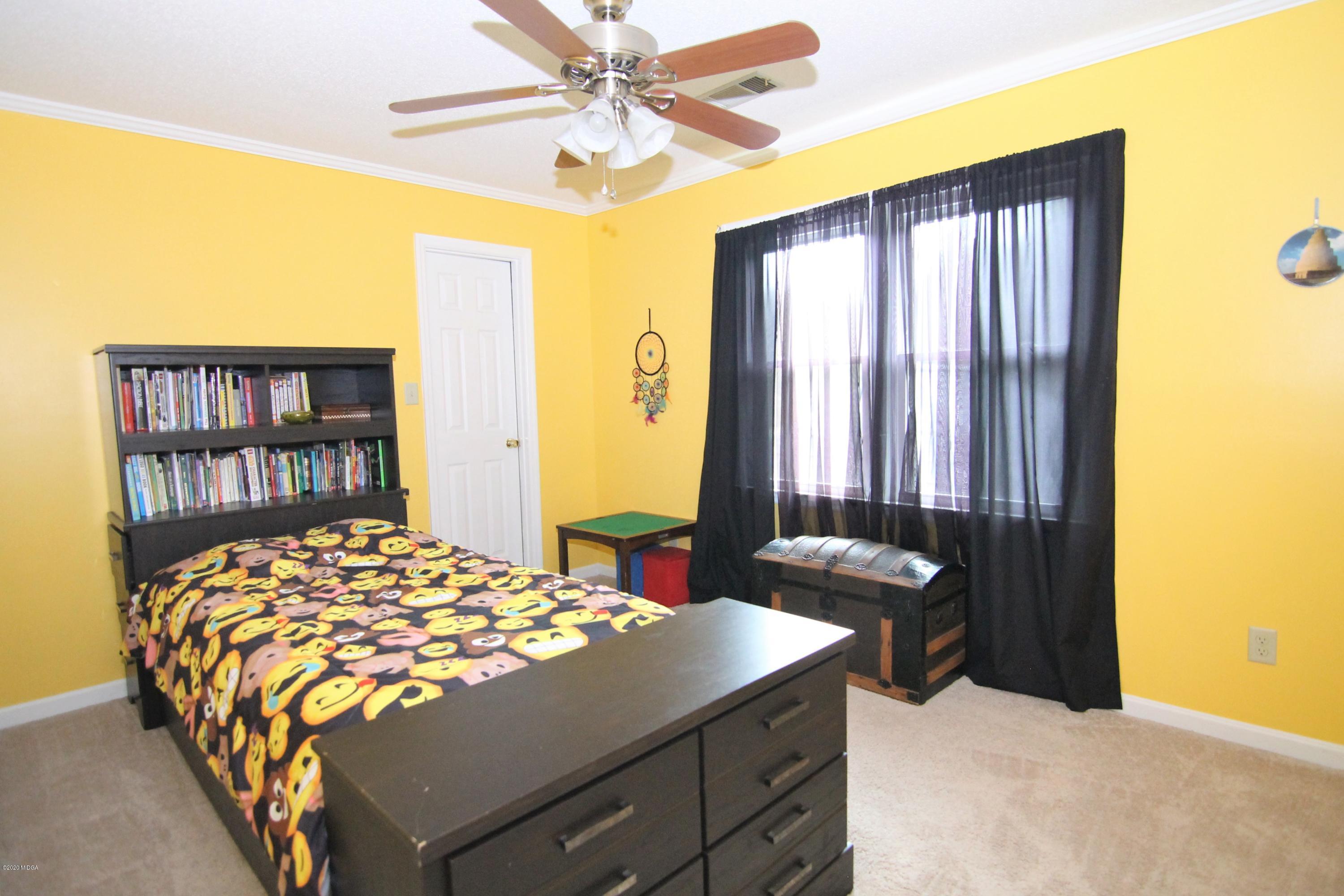 205 Cedar Ridge Drive Perry, GA 31069 - Photo 22 of 39 a bedroom with a bed and a dresser