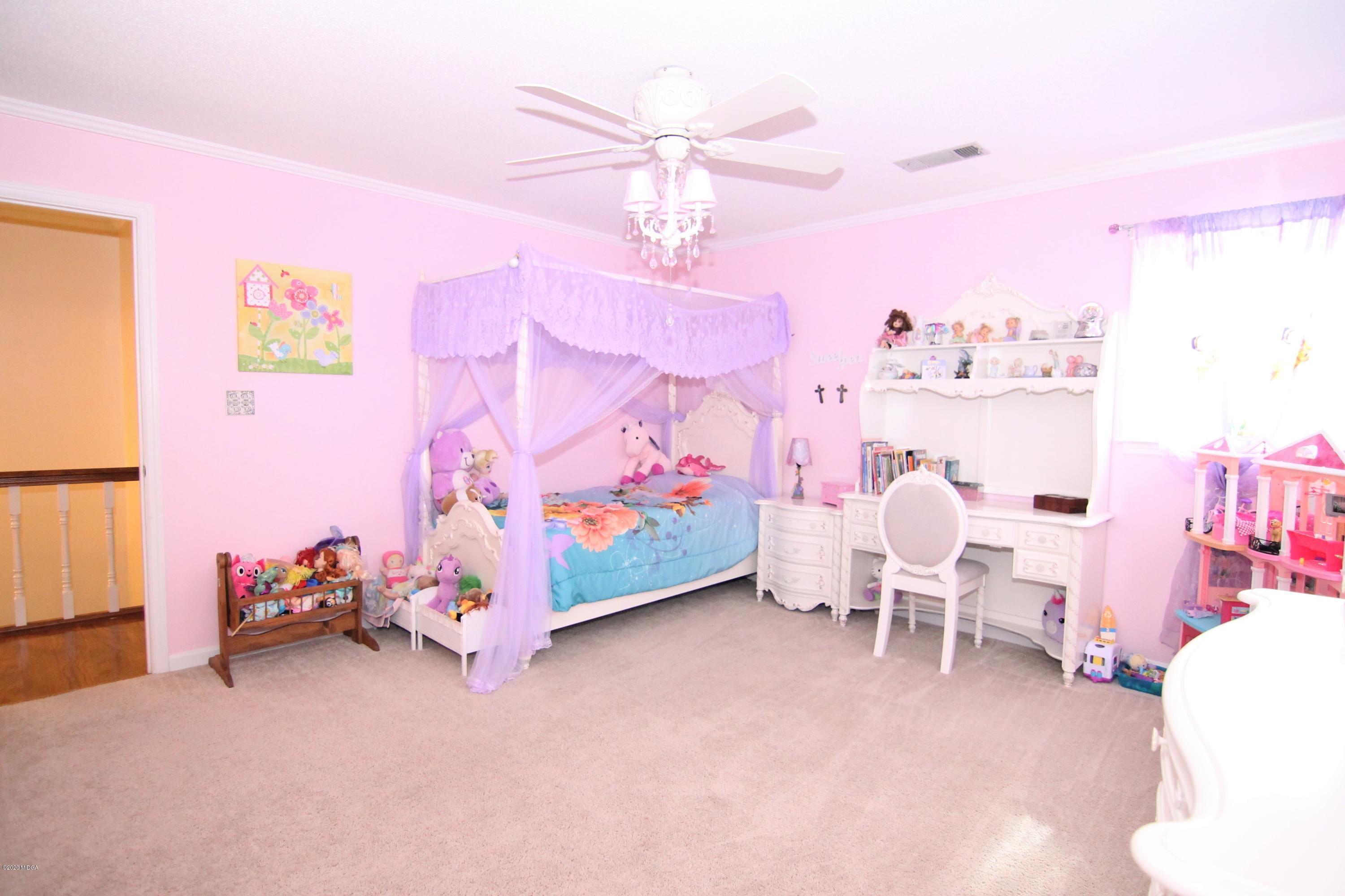 205 Cedar Ridge Drive Perry, GA 31069 - Photo 27 of 39 a bedroom with furniture and a bed