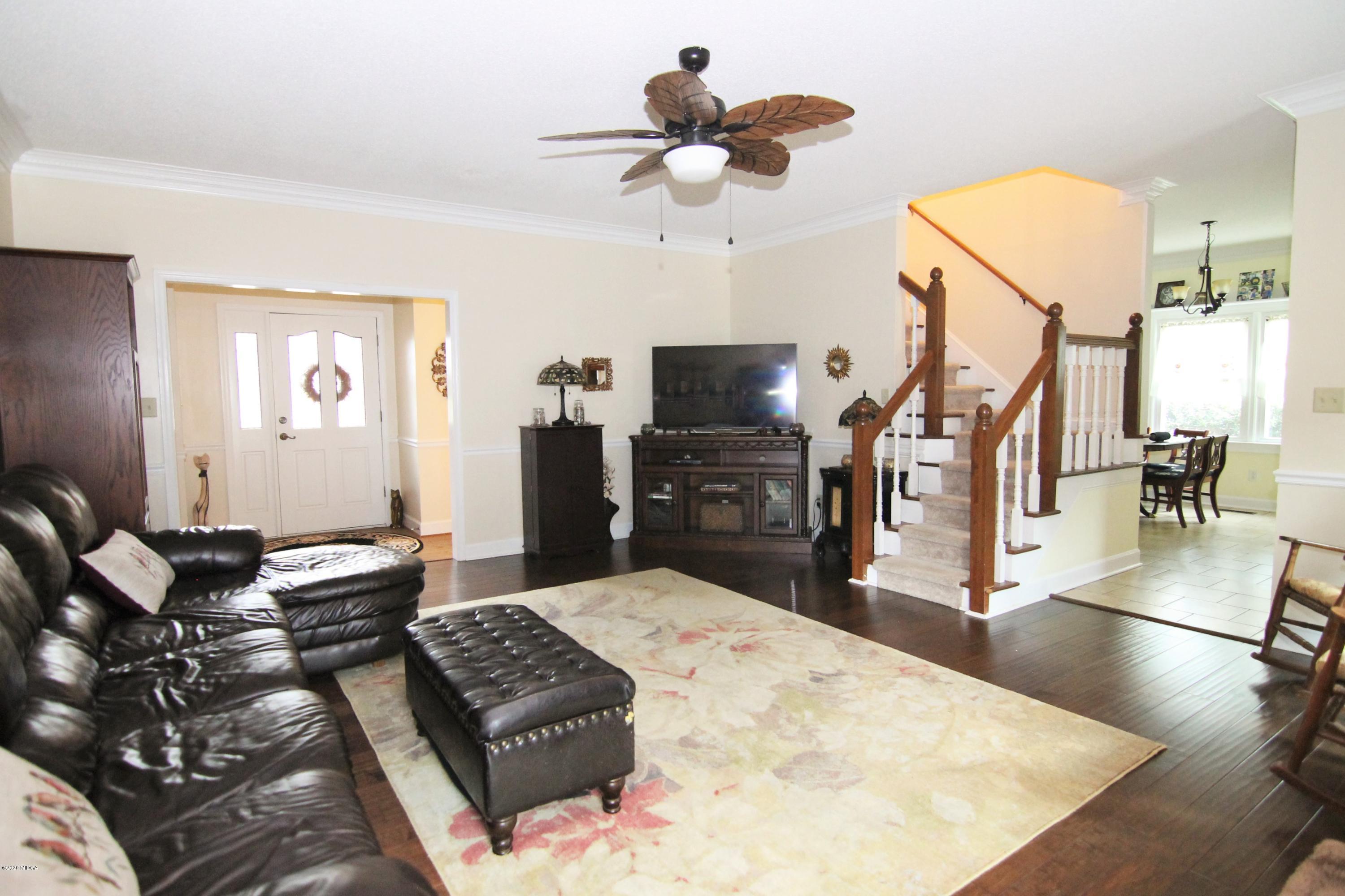 205 Cedar Ridge Drive Perry, GA 31069 - Photo 4 of 39 a living room with furniture and a flat screen tv