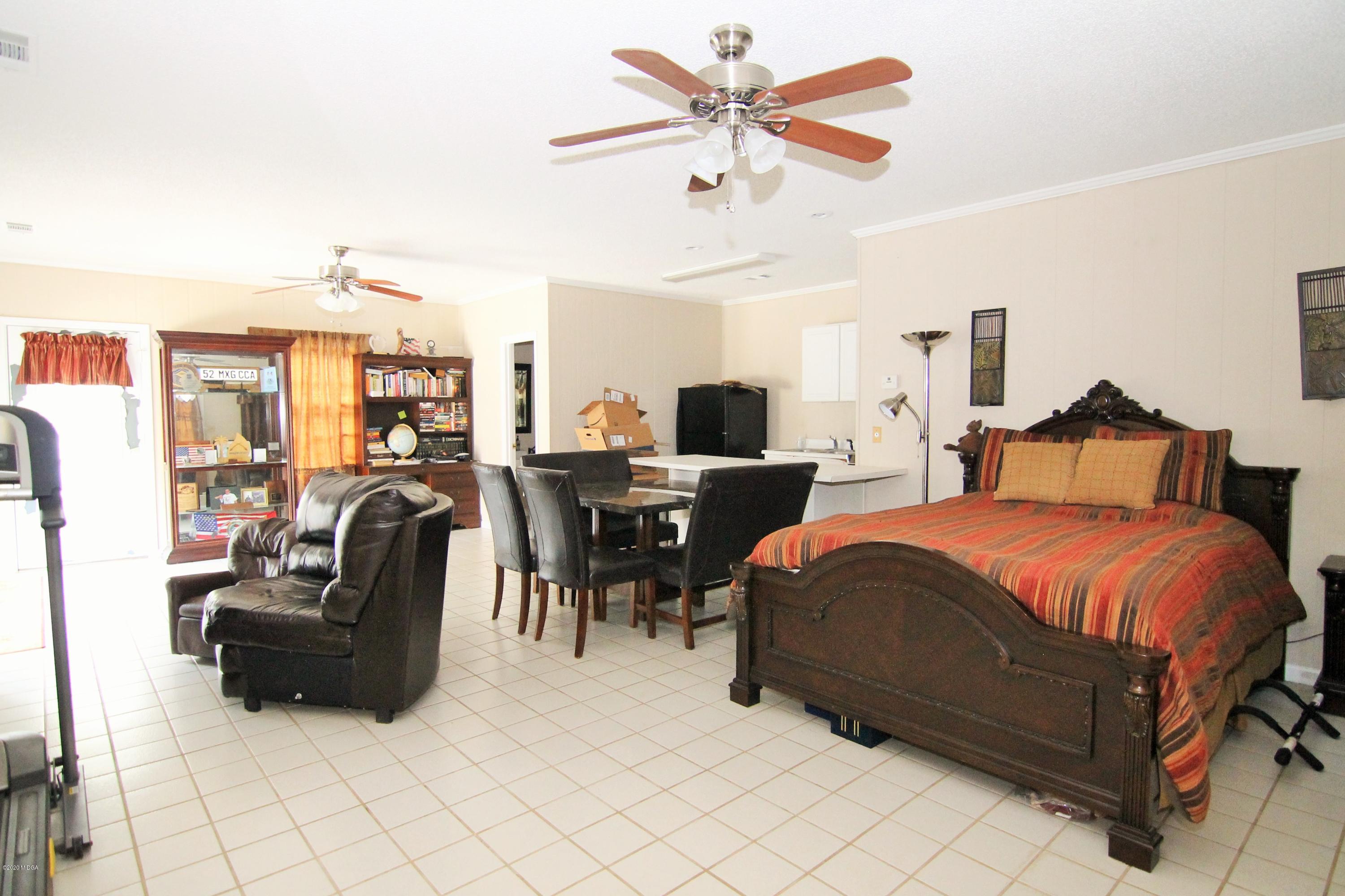 205 Cedar Ridge Drive Perry, GA 31069 - Photo 31 of 39 a bedroom with a bed and ceiling fan
