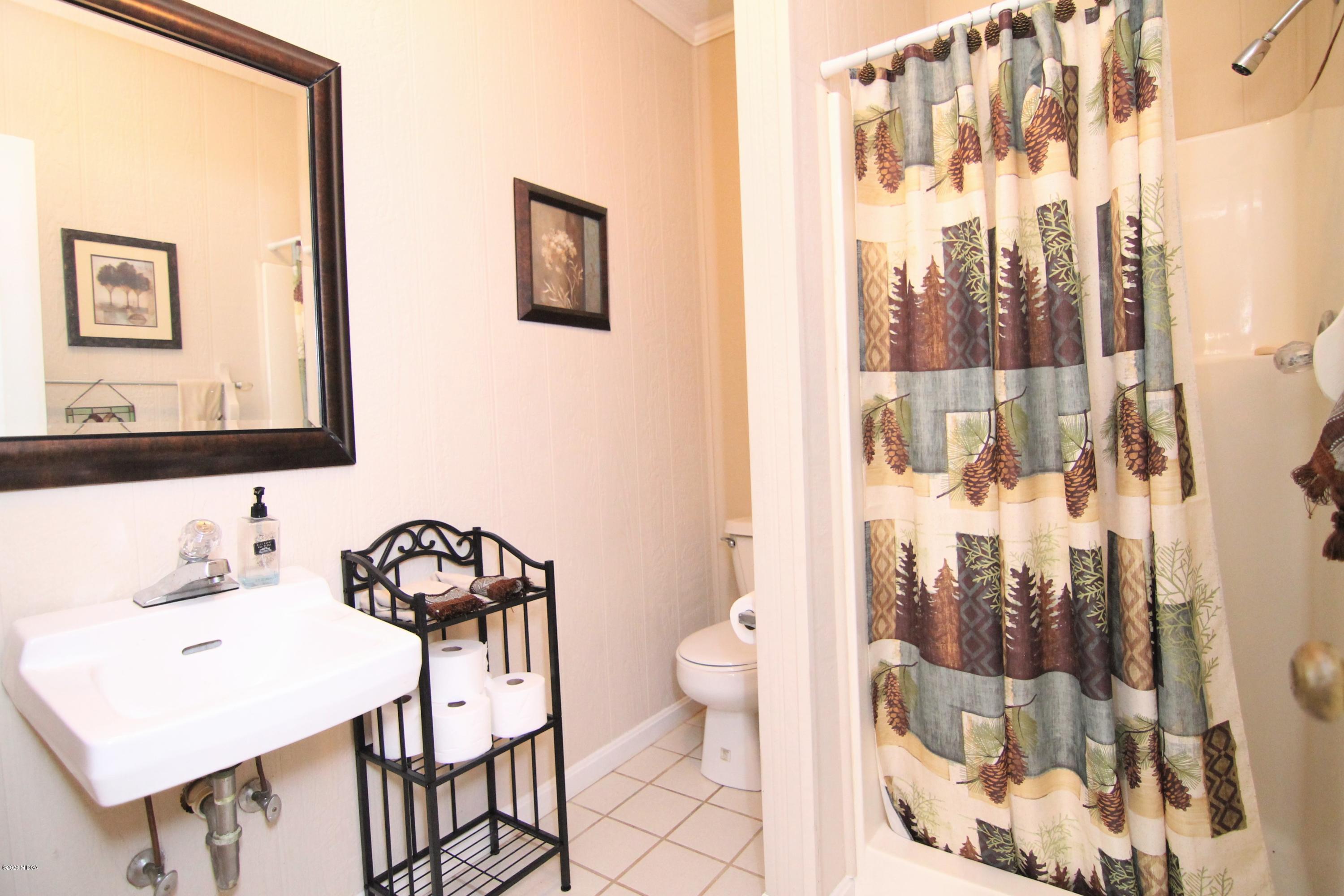205 Cedar Ridge Drive Perry, GA 31069 - Photo 32 of 39 a bathroom with a sink toilet and shower