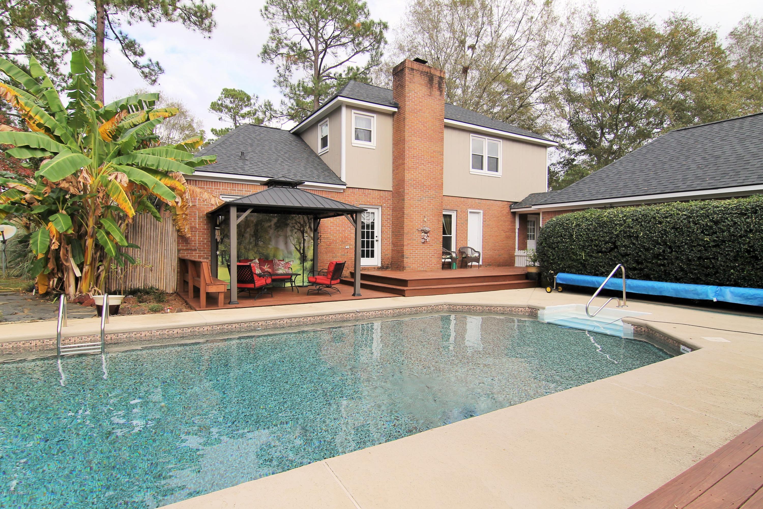 205 Cedar Ridge Drive Perry, GA 31069 - Photo 39 of 39 a view of a swimming pool with chair and tables