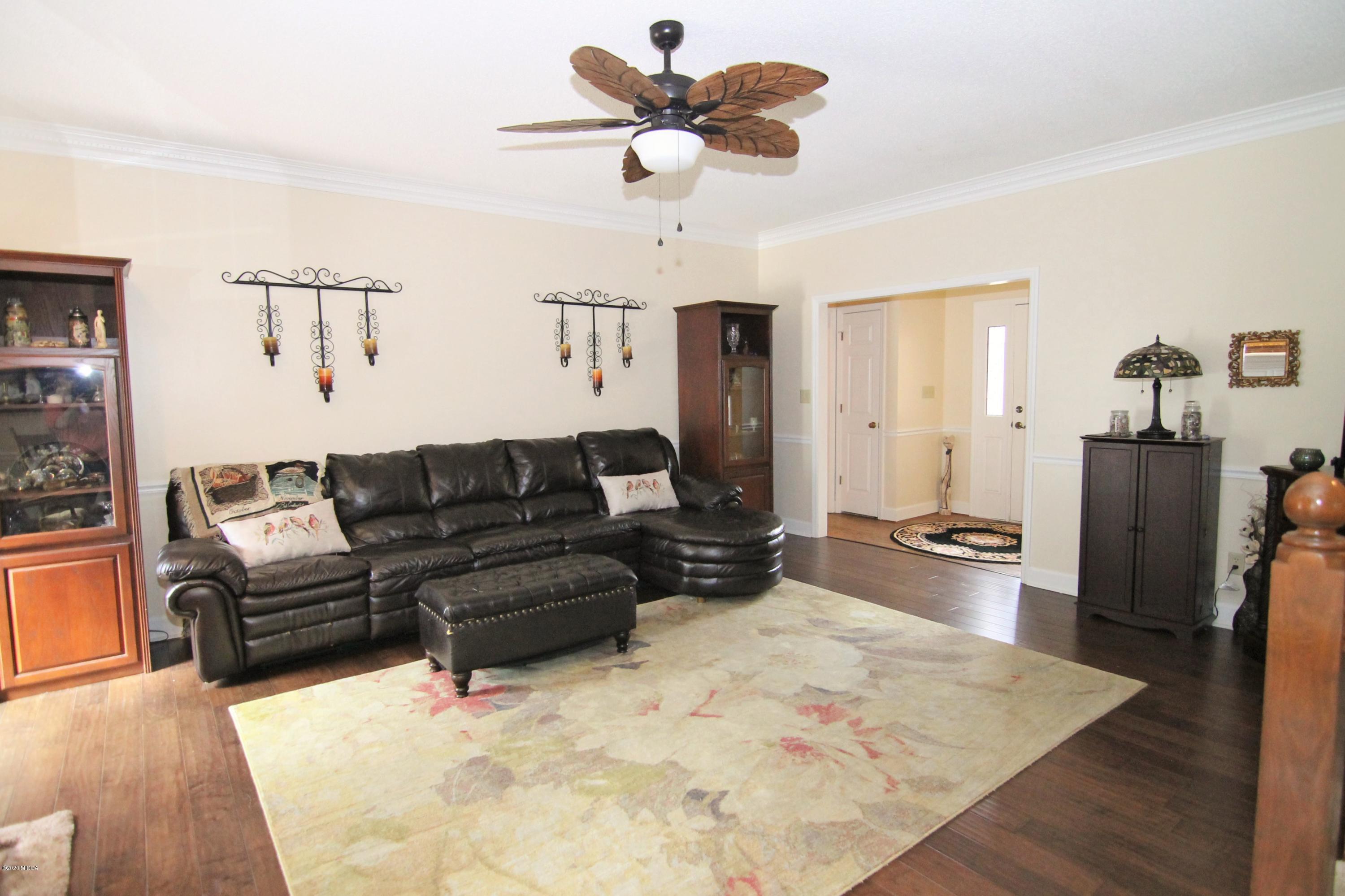 205 Cedar Ridge Drive Perry, GA 31069 - Photo 5 of 39 a living room with furniture and a wooden floor