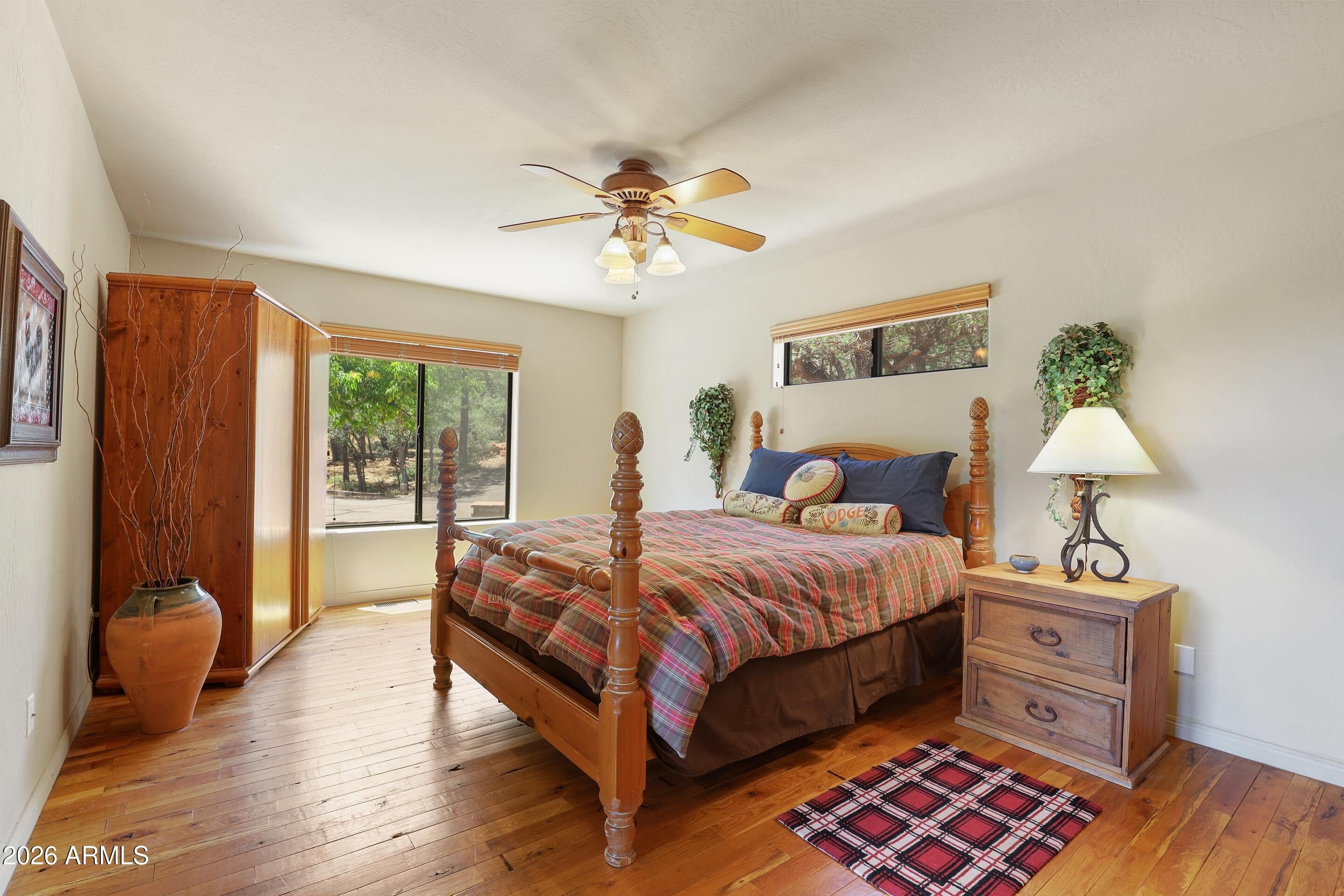 5837 Arroyo Way Pine, AZ 85544 - Photo 11 of 30 a bedroom with a bed and wooden floor