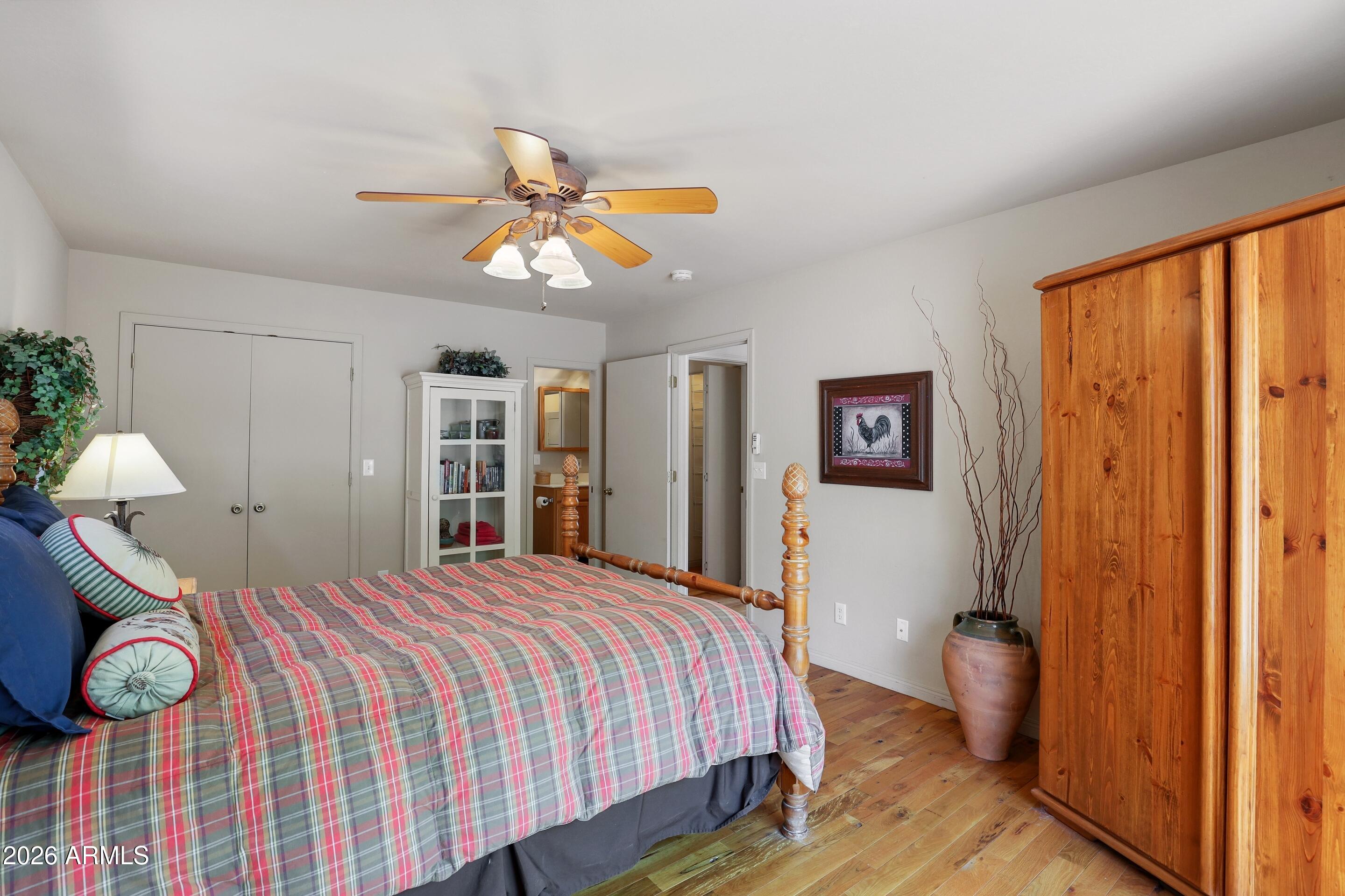 5837 Arroyo Way Pine, AZ 85544 - Photo 12 of 30 a bedroom with a bed and a chandelier
