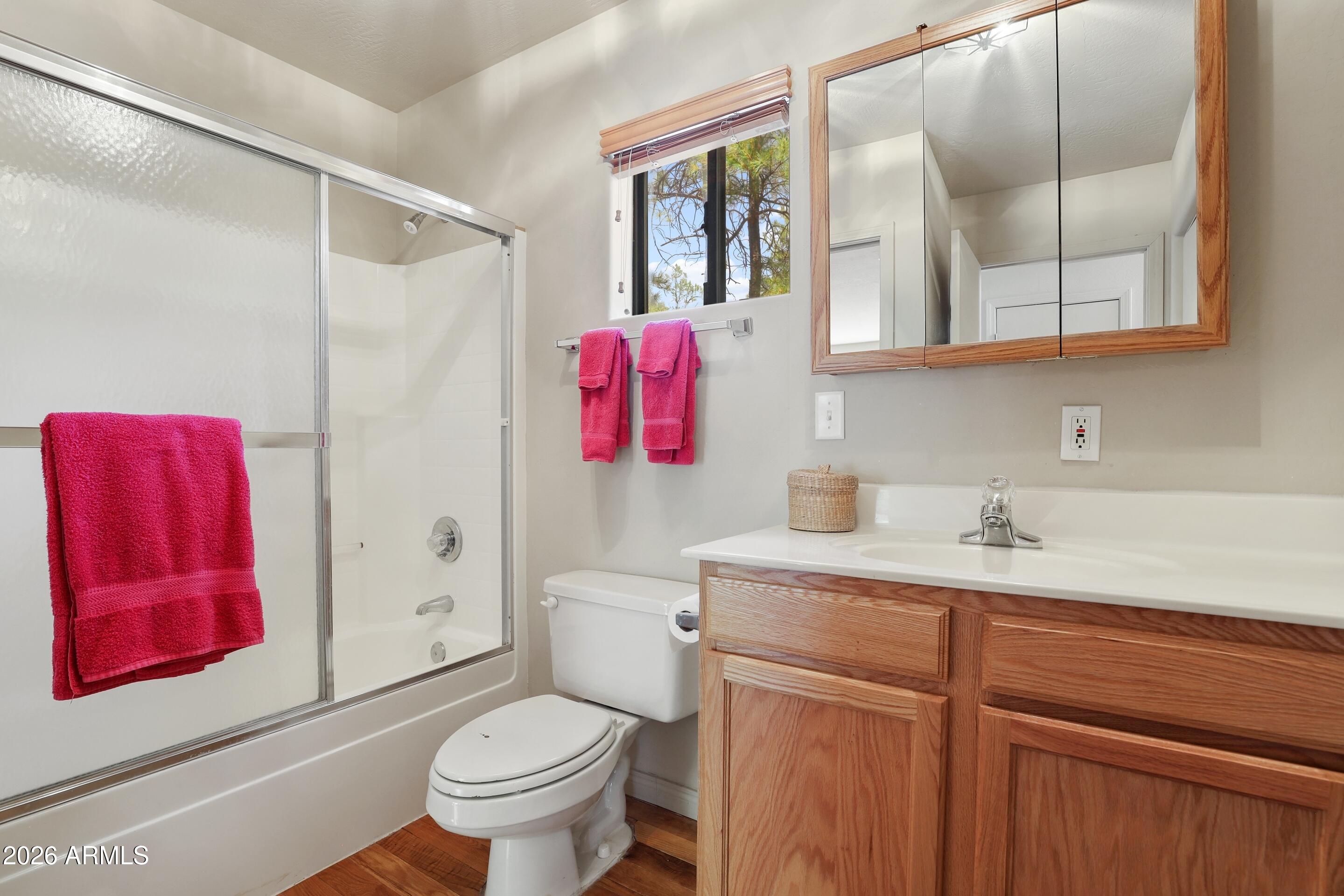 5837 Arroyo Way Pine, AZ 85544 - Photo 13 of 30 a bathroom with a sink vanity mirror and toilet