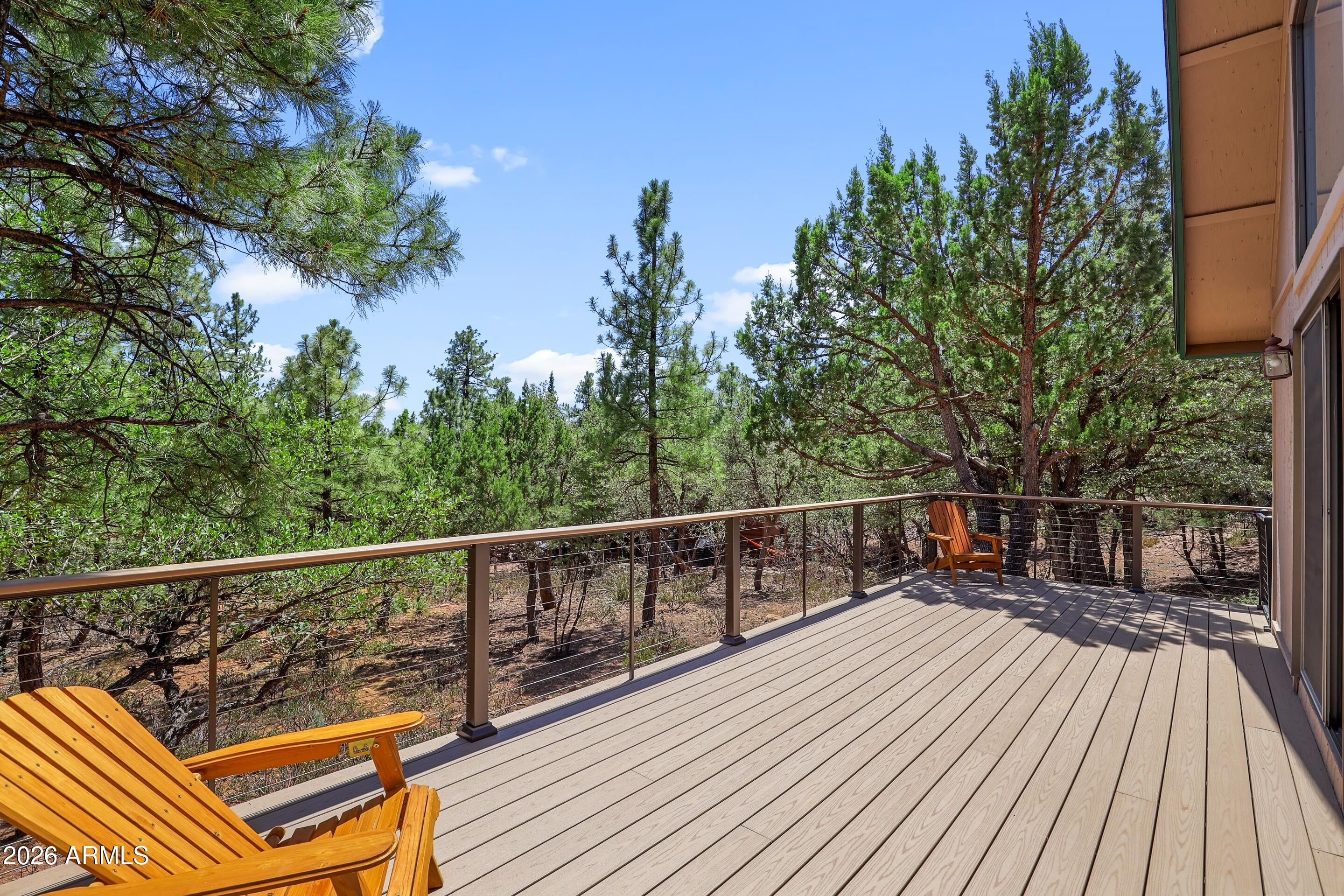 5837 Arroyo Way Pine, AZ 85544 - Photo 21 of 30 a view of balcony with wooden floor and outdoor seating