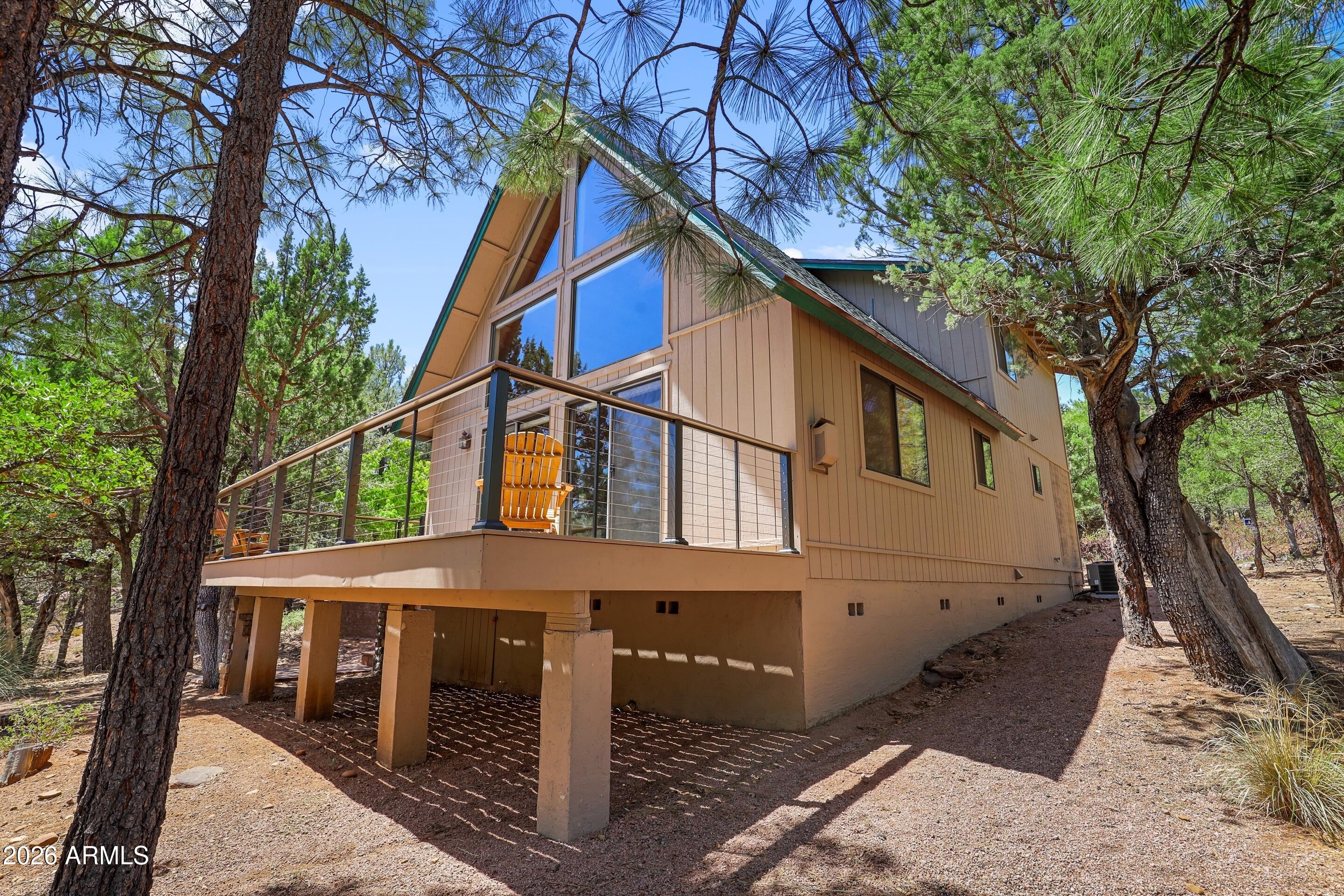 5837 Arroyo Way Pine, AZ 85544 - Photo 3 of 30 a view of house with a tree and wooden fence