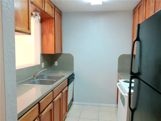 a bathroom with a granite countertop sink and a bathtub