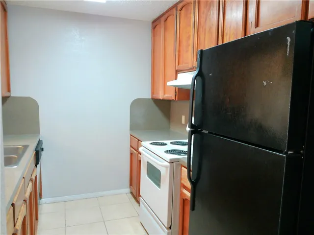 a kitchen with a refrigerator and window